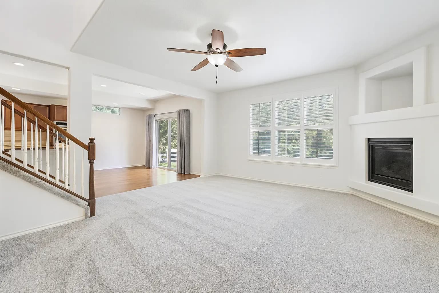 Empty living room with fireplace before virtual staging